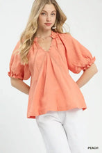 Peach-colored umgee cotton gauze ruffle top with puff sleeves and delicate eyelet embroidery at the neckline