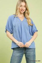 Light blue umgee cotton gauze ruffle top with textured fabric, ruffled sleeves, and delicate lace neckline detailing