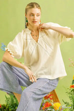 Cream-colored umgee cotton gauze ruffle top with delicate embroidery and lightweight ruffled sleeves
