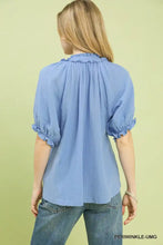 Light blue cotton gauze blouse with textured fabric, ruffled neckline, and puffed sleeves from umgee cotton gauze ruffle top