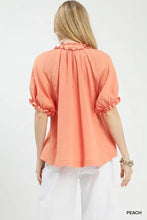 Peach-colored umgee cotton gauze ruffle top with puffed sleeves and ruffled neckline in lightweight cotton gauze fabric