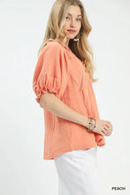 Peach-colored umgee cotton gauze ruffle top with textured fabric puffed sleeves and lace detail at the neckline