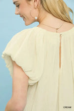 Cream-colored lightweight chiffon crinkle flutter sleeve peasant top with puffy short sleeves and back keyhole detail