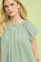 Mint-colored lightweight chiffon umgee crinkle flutter sleeve peasant top with puffed sleeves and gathered neckline