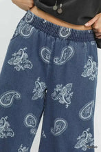 Umgee denim paisley wide-leg pants in blue indigo denim featuring a white paisley print across the fabric