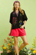 Black umgee embroidered floral blouse features pink trim short sleeves and v-neck design perfect for stylish wear