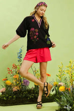 Umgee embroidered floral black blouse with pink trim and puff sleeves featuring embroidered floral design