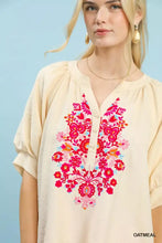 Cream-colored umgee embroidered puff sleeve blouse with vibrant pink red and orange floral embroidery across front