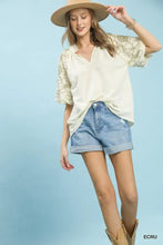 Cream-colored umgee embroidered boho blouse features floral embroidery on the sleeves with a v-neck design