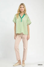 Umgee embroidered stripe short-sleeved blouse in light green and white with floral embroidery and emerald green v-neckline
