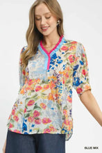 Umgee floral contrast pleat neck top with vibrant floral print blouse featuring v-neckline and ruffled blue and pink trim