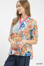 Umgee floral contrast pleat neck top featuring vibrant blue pink orange floral print with ruffled sleeves and bright collar