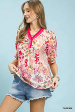 Umgee floral contrast pleat neck top in pastel reds pinks and yellows with vibrant pink v neckline and three quarter sleeves