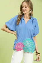 Umgee vibrant blue blouse with oversized puff sleeves and bold floral embroidered hem appliqués in pink and teal