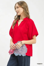 Red short-sleeved umgee blouse with v-neck and floral embroidered hem featuring intricate puff sleeves detail