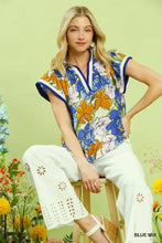 Umgee floral print blouse with vibrant blue orange and white blossoms and navy contrast trim on collar and sleeves