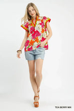 Umgee floral print blouse with contrast trim featuring bold pink and orange blossoms on a cream background
