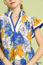 Umgee floral print blouse with bold blue and orange blossoms on white background featuring navy contrast trim