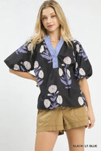 Black umgee floral print blouse with light blue embroidered collar and puff sleeves featuring white and purple floral embroidery