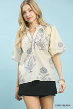 Beige umgee floral print v-neck blouse with short sleeves featuring a black botanical design for casual wear