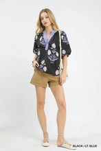 Black umgee floral print blouse with light blue embroidered collar white floral patterns and short puffed sleeves