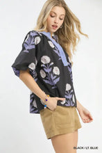 Black blouse with umgee floral print featuring light blue trim and white lavender embroidered floral pattern