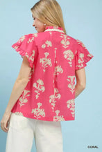 Coral-colored umgee floral ruffle sleeve split neck top with white floral embroidery and ruffled short sleeves