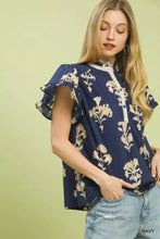 Navy blue umgee floral ruffle sleeve split neck blouse with cream-colored floral embroidery and ruffled short sleeves