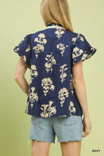 Navy blue Umgee split neck blouse with cream floral ruffle sleeve embroidery and ruffled short sleeves
