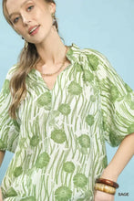Umgee floral scalloped edge puff sleeve blouse in sage green with white floral print, v-neckline, and high-low hem