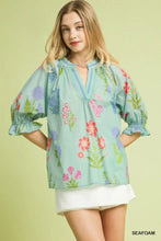 Light green umgee floral split neck puff sleeve top with v-neckline and puffed sleeves in lightweight fabric