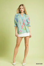Light blue umgee floral split neck puff sleeve blouse with ruffled sleeves and v-neckline for casual wear