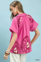 Umgee floral split-neck short sleeve top in vibrant pink with bold peony print and white stitching along edges and neckline