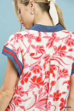 Women’s umgee floral split neck blouse with vibrant pink red floral pattern on off-white background and navy trim