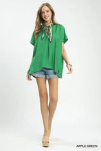 Apple green umgee flowy v-neck short sleeve blouse with tie-front design and subtle side slits for a stylish look