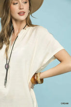 Cream-colored umgee flowy v-neck short sleeve blouse with loose fit for casual and office wear