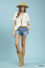 Umgee cream-colored flowy short sleeve blouse with v-neck and relaxed fit for casual and versatile wear