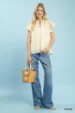 Cream-colored lightweight umgee flutter sleeve blouse with ruffled short sleeves and delicate lace trim hem