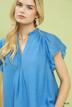 A vibrant blue lightweight cotton flutter sleeve relaxed blouse with ruffled sleeves and scalloped edge trim detail