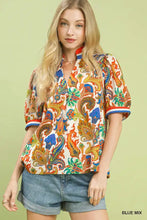 Umgee jacquard abstract short-sleeved blouse with colorful paisley print and striped cuffs on off-white background