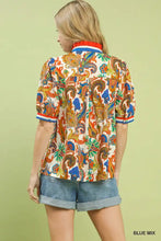 Umgee jacquard abstract print top with vibrant paisley print in orange blue and green on off-white fabric with red and blue trim