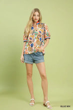 Umgee jacquard abstract short-sleeved blouse with vibrant paisley print in orange blue and brown with red white trim
