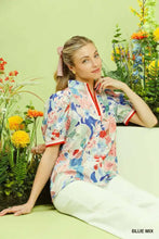 Umgee jacquard bloomscape floral print short-sleeved blouse with red zipper trim and blue pink white blossoms