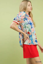 Umgee jacquard bloomscape floral print short-sleeved top with vibrant blue and pink colors and red cuff trim