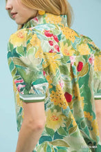 Umgee jacquard bloomscape print top featuring a vibrant floral print with yellow red and green blossoms on light fabric