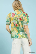 A vibrant green and yellow umgee jacquard bloomscape short-sleeved blouse with puffed sleeves and white trim collar