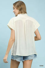 Cream-colored umgee lace button-front sheer blouse with short sleeves and delicate lace trim along side seam
