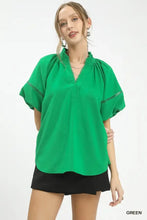 Vibrant green umgee lace trim peasant top with gathered neckline and delicate lace trim along short sleeves cuffs