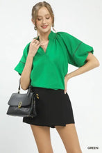 Black textured handbag with gold-tone hardware complementing umgee lace trim peasant top style and elegance