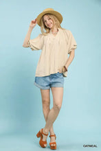 Beige umgee linen v neck flutter sleeve top with ruffled soft fabric and subtle pleats at the neckline